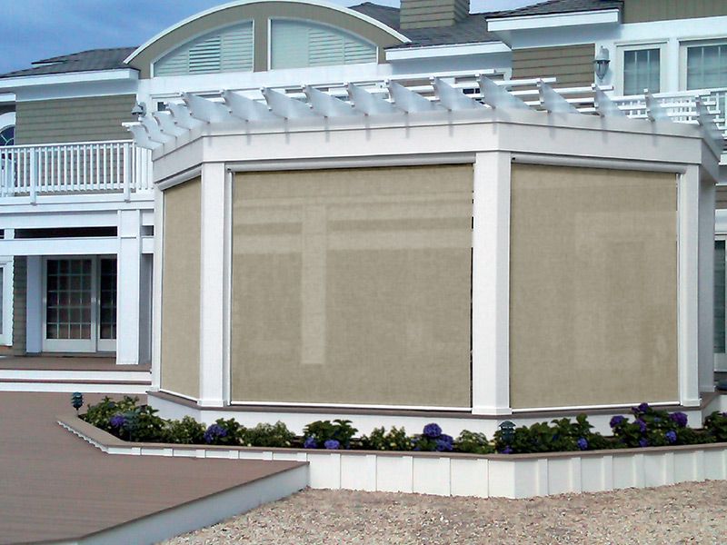 A Sunroll retractable screen lowered across a bright pergola opening