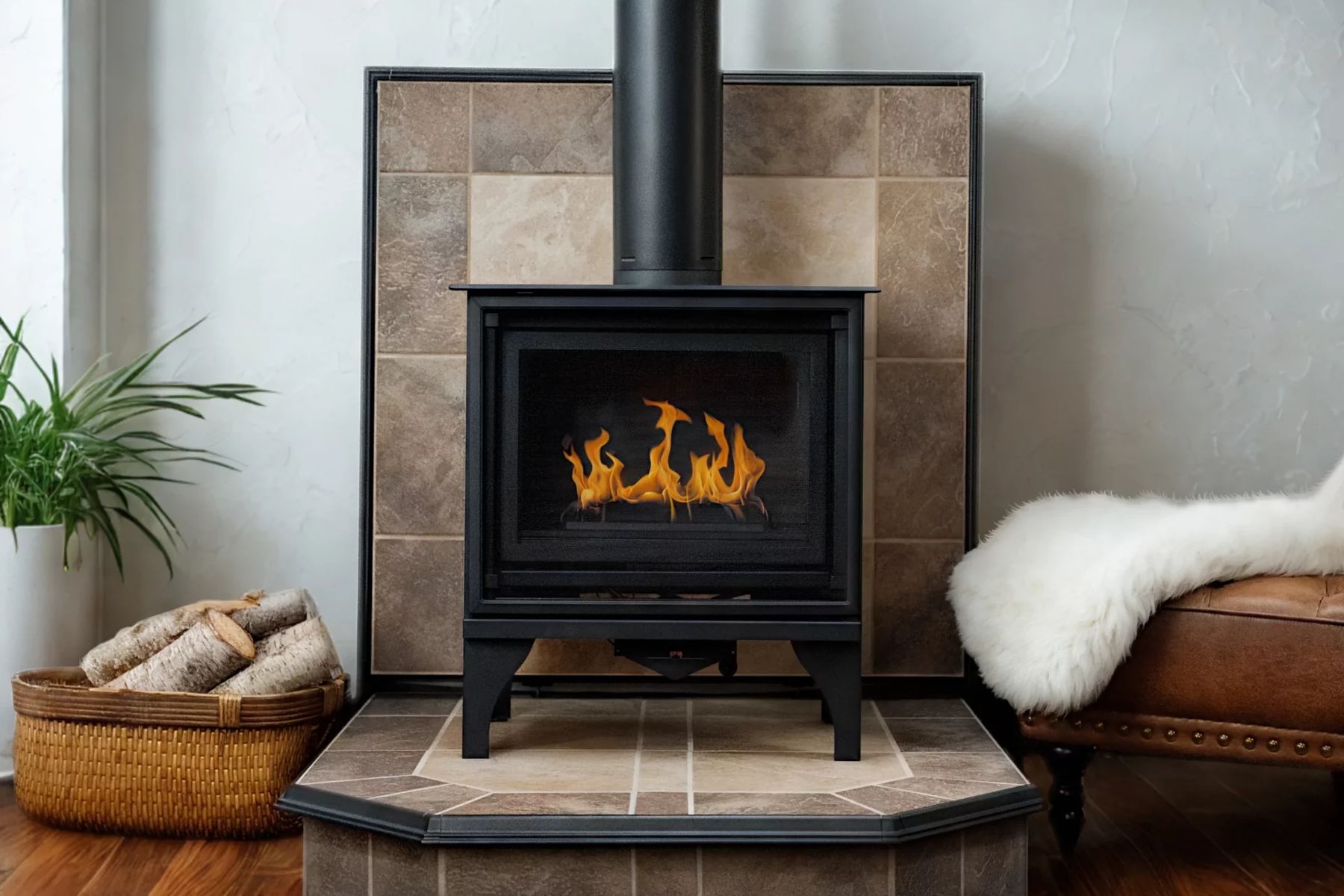 A wood stove on a tile hearth pad with a matching wall pad behind it