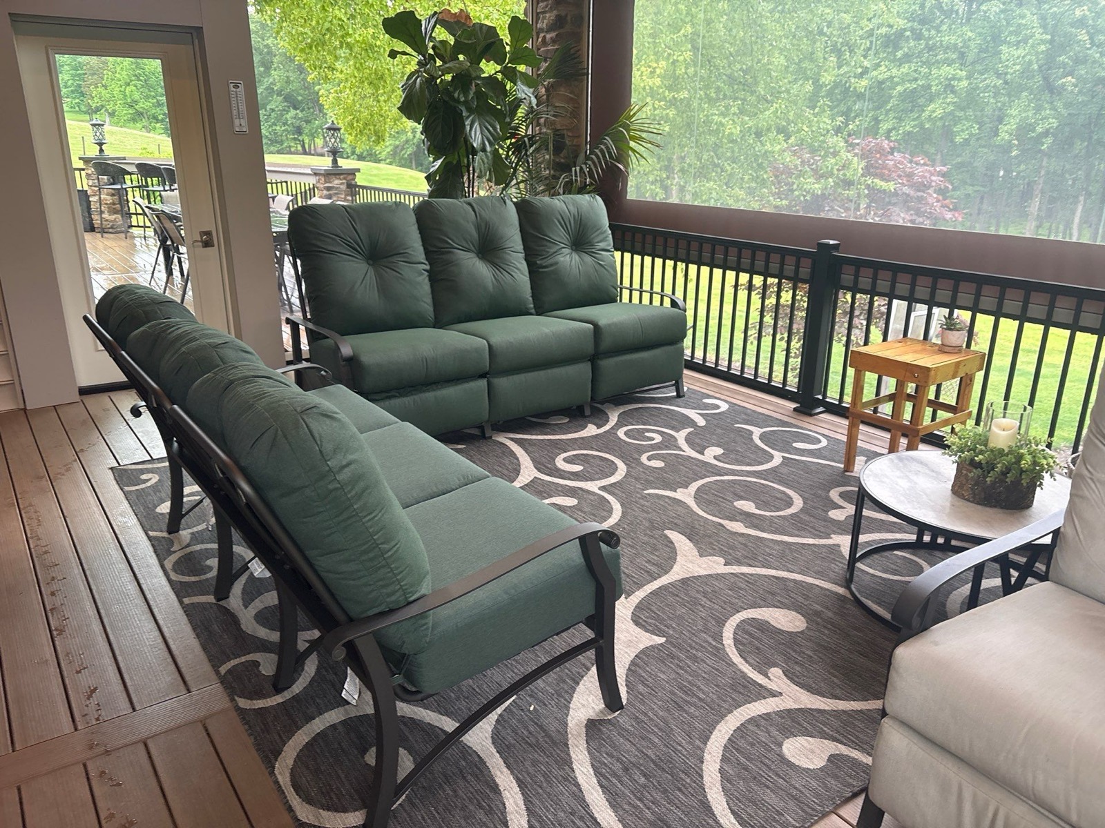 A comfortable covered porch outdoor living space furnished by Bowman's Stove & Patio